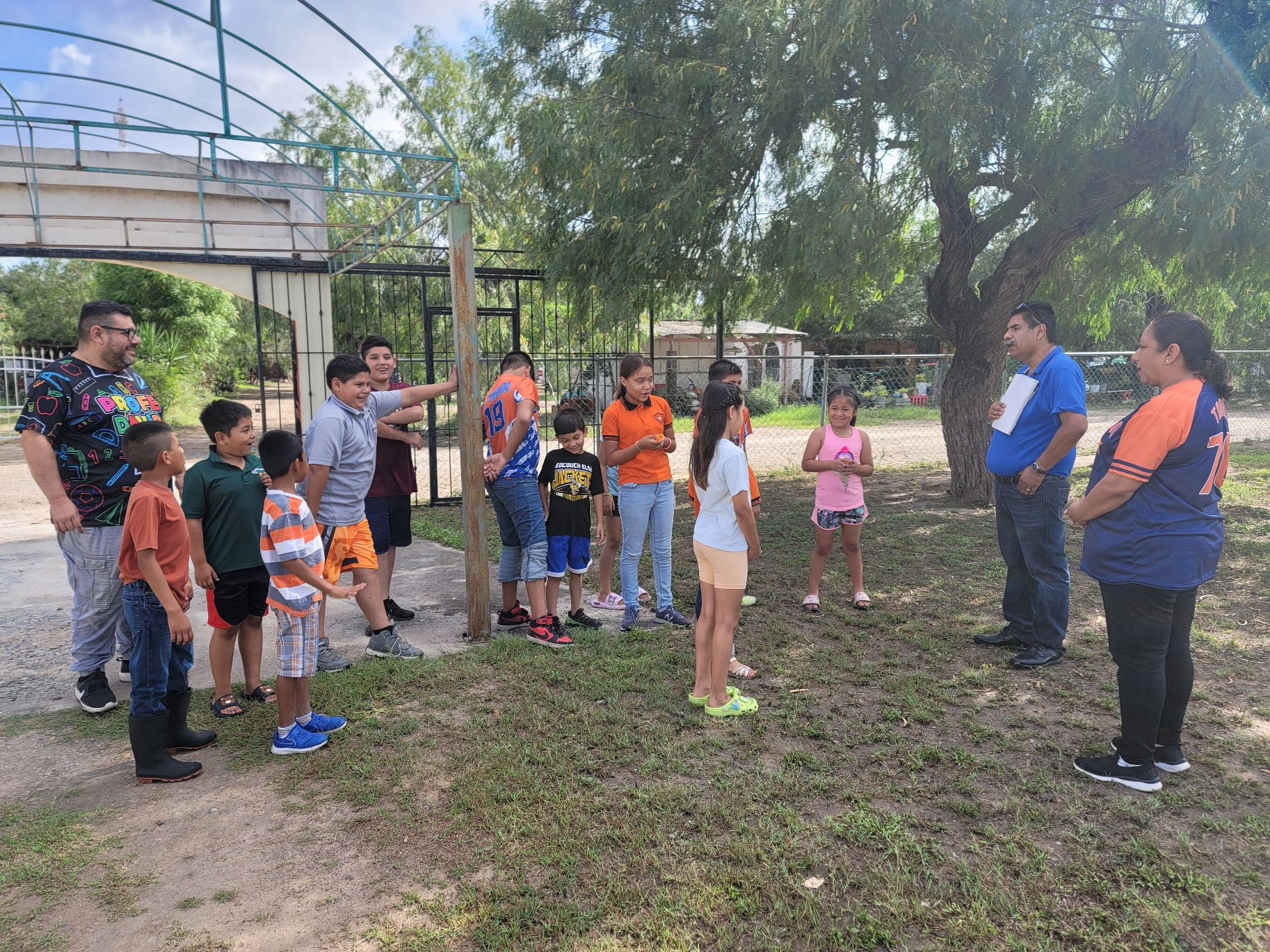 A group of children standing in a circle
AI-generated content may be incorrect.