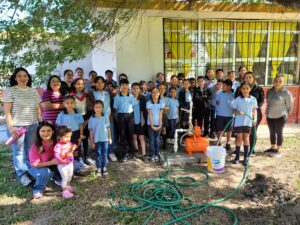 A group of children standing in front of a building AI-generated content may be incorrect.