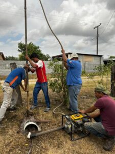A group of men working on a hole in the ground AI-generated content may be incorrect.