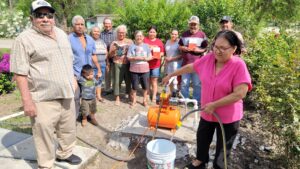 A group of people standing around a person pouring water into a bucket AI-generated content may be incorrect.