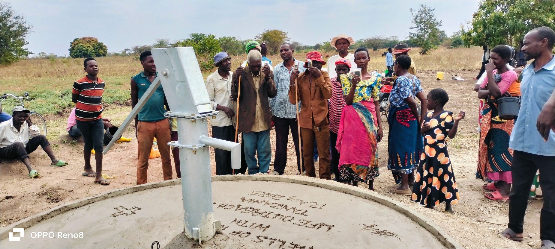A group of people standing around a well
AI-generated content may be incorrect.