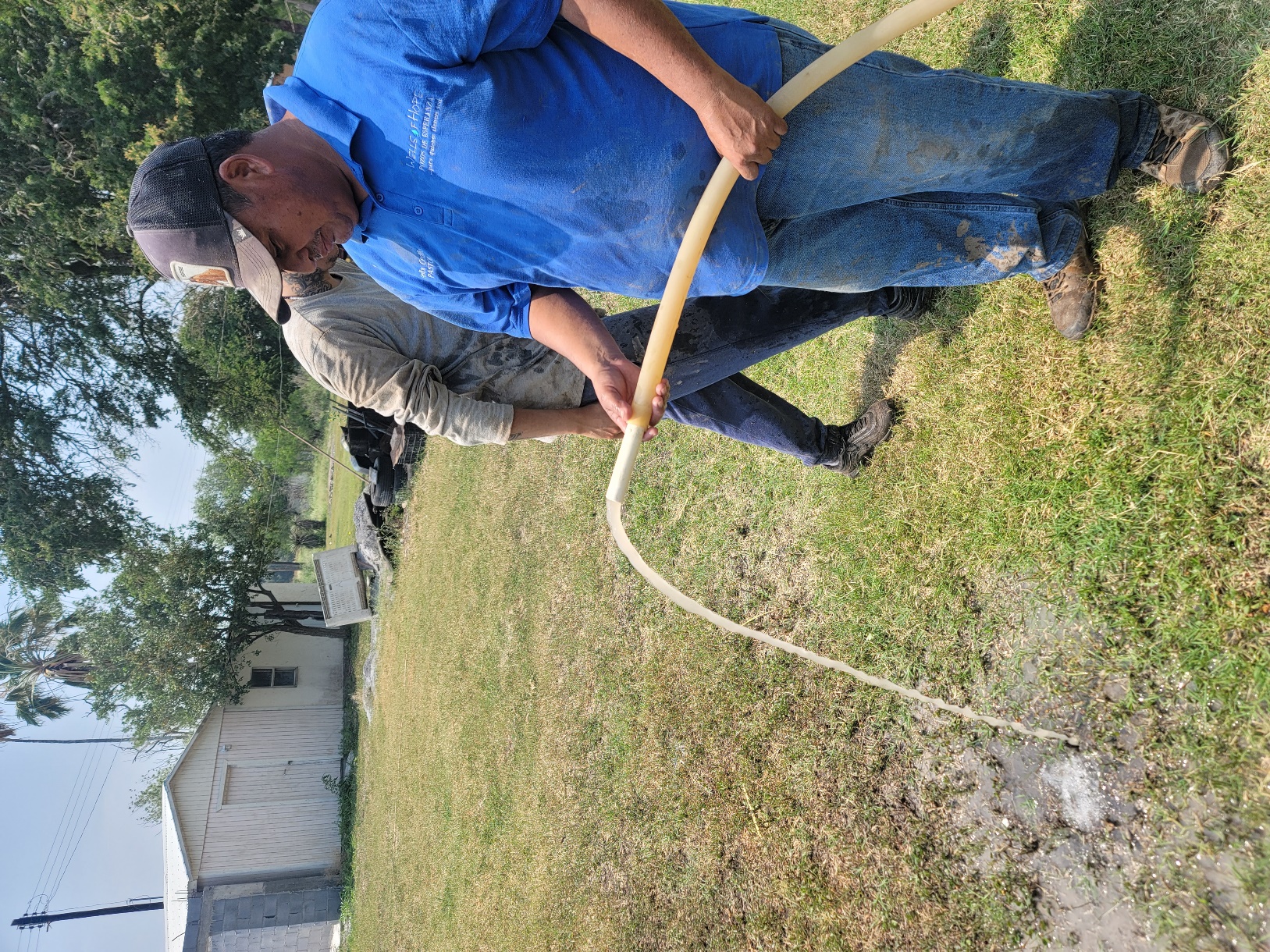 A person and person holding a hose
AI-generated content may be incorrect.
