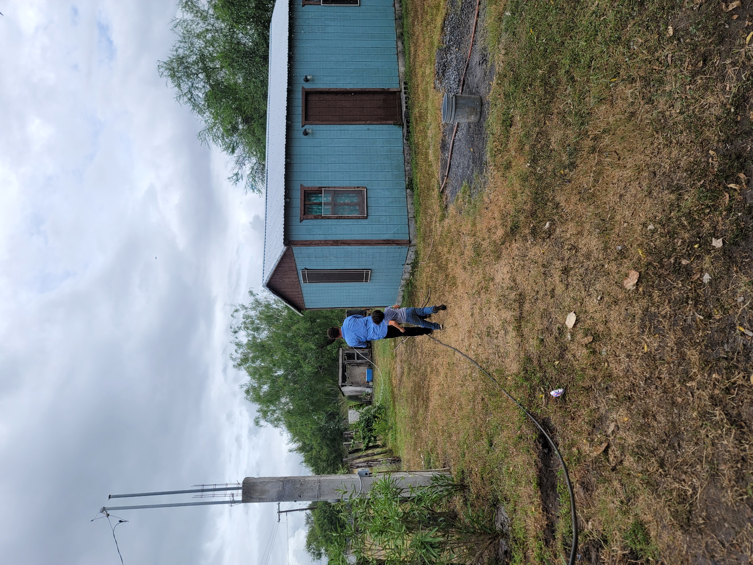 A person and person standing in a yard
AI-generated content may be incorrect.