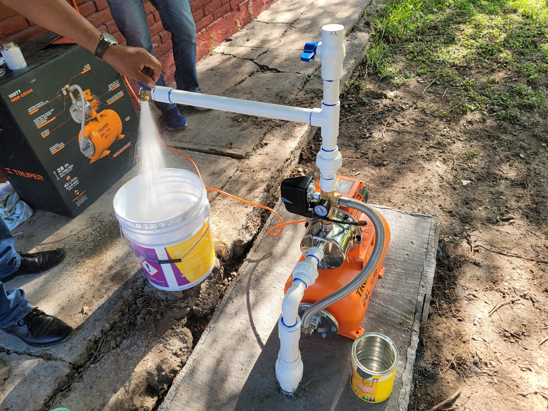 A person spraying water on a machine
AI-generated content may be incorrect.