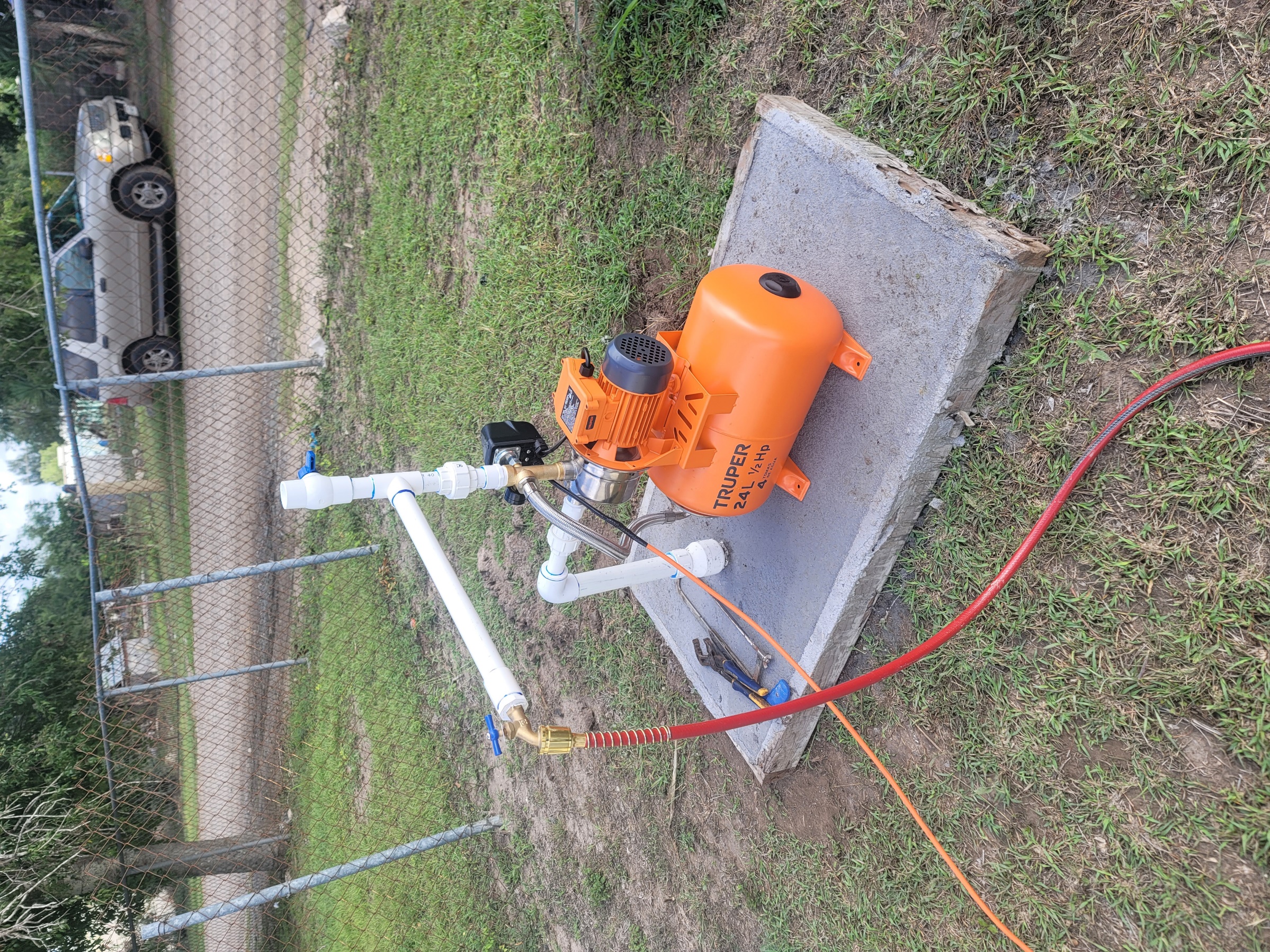 A water pump on a concrete slab
AI-generated content may be incorrect.