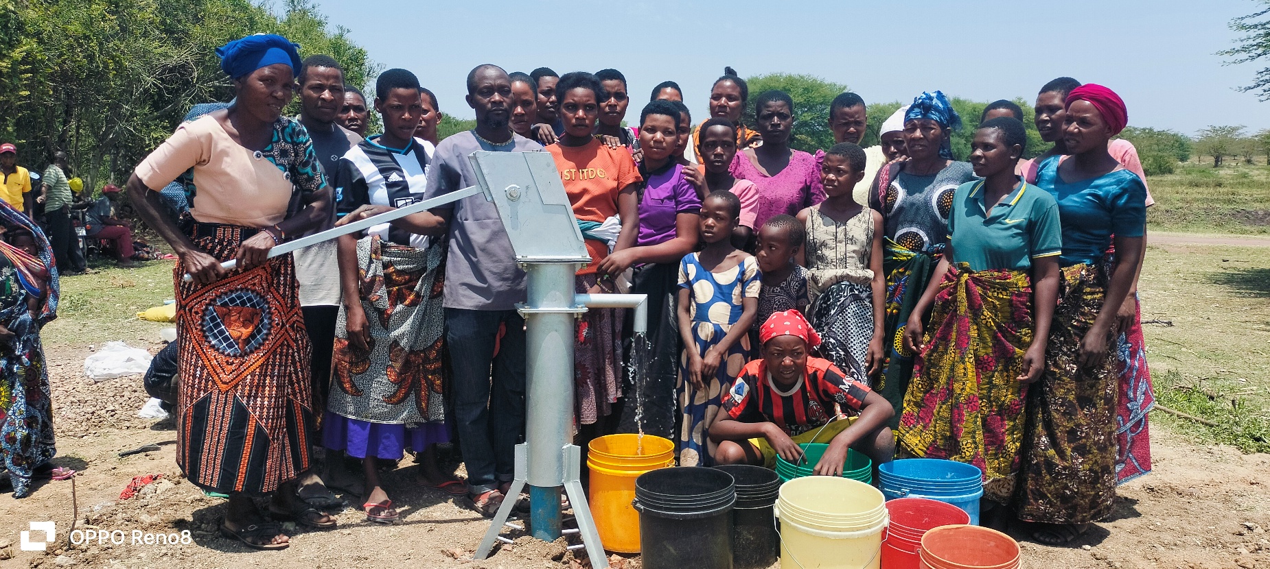 A group of people standing next to a water pump

AI-generated content may be incorrect.